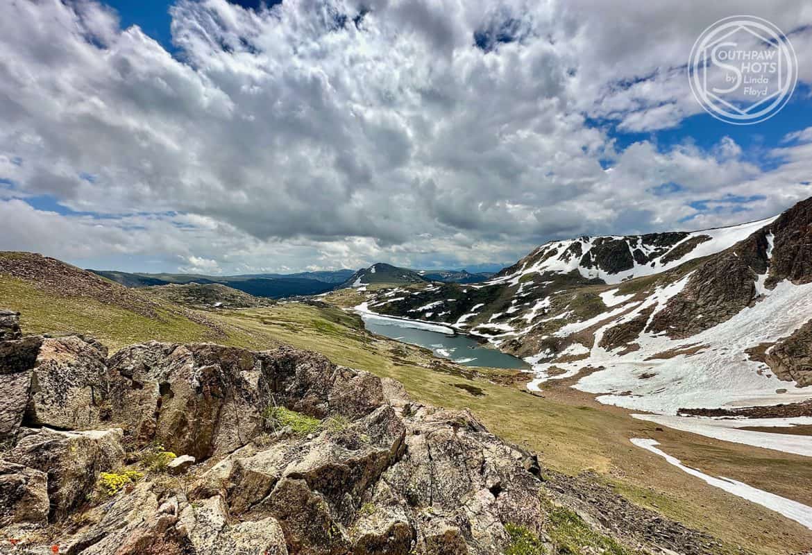 a landscape with snow and a river