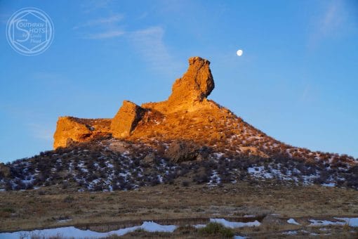 a mountain with a moon in the background
