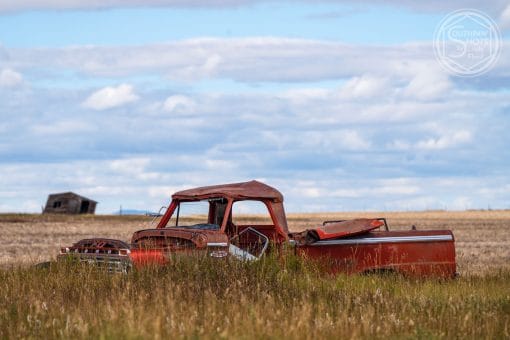 an old rusted truck in a field