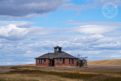 a brick building in a field