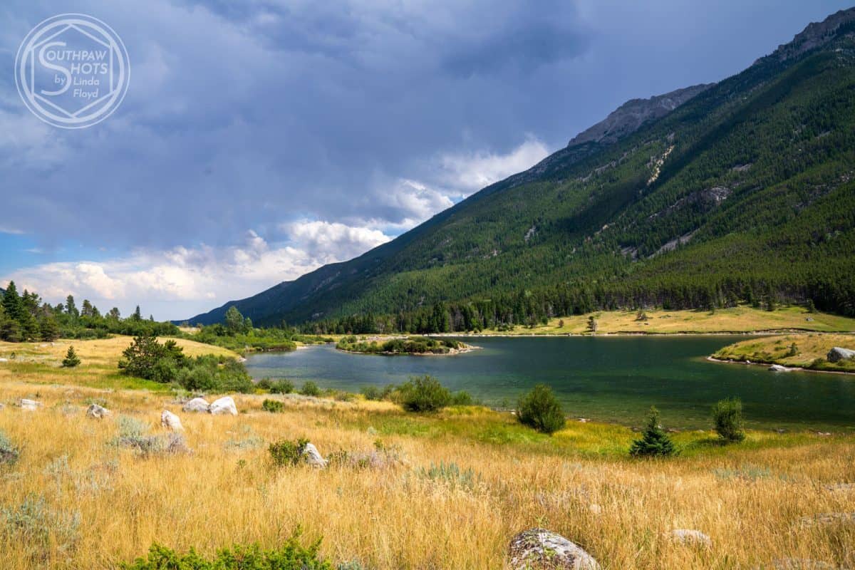 a lake surrounded by trees and mountains